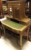 A Victorian style writing desk with mirrored cupboard doors,
