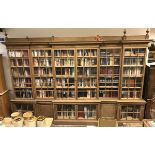 A large oak framed break front bookcase in the Arts & Crafts taste with glazed and barred doors top