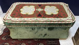 A 19th Century waisted ottoman with green velvet upholstery and needlework decorated top raised on