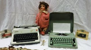 A Hermes Baby manual typewriter, an Olympia manual typewriter,