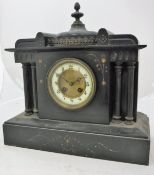 A 19th Century French black marble cased mantel clock of architectural form with eight day movement