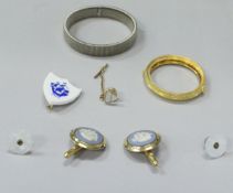 A box containing various collar studs,