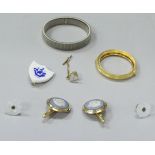 A box containing various collar studs,