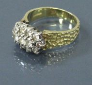 An 18 carat gold bark effect ring with diamond cluster of thirteen diamonds,