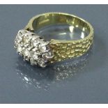 An 18 carat gold bark effect ring with diamond cluster of thirteen diamonds,