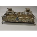 A Victorian pierced silver rectangular desk stand with two silver mounted cut glass inkwells (by