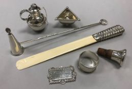 A silver Guernsey cream jug, a silver handled ivory paperknife, a silver candle snuffer,