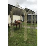 A set of three wirework arches together with a metal three tier plant stand