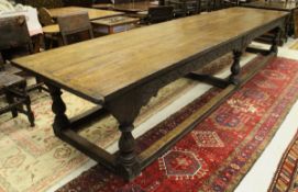 An oak refectory style dining table in the 17th Century manner the four plank top with cleated ends