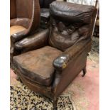 A circa 1900 brown leather upholstered button back armchair on square tapered stained beech