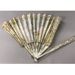 A 19th Century French mother of pearl stick fan with hand painted decoration of classical maiden