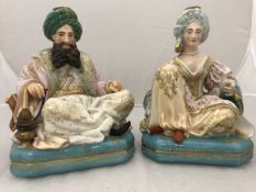 A pair of 19th Century Jacob Petit porcelain dressing table scent bottles as seated Turks,