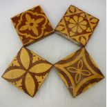 Four glazed terracotta tiles in the encaustic style by W.