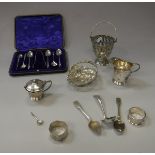 A collection of small silver wares to include a small pierced basket, sugar basket (liner missing),
