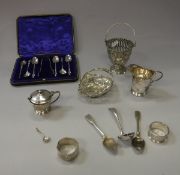 A collection of small silver wares to include a small pierced basket, sugar basket (liner missing),