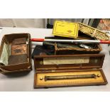 A collection of items to include various wooden rules, a box of assorted copper printing blocks,