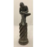 A bronze study of Spinario seated on a rock picking thorn from his foot raised on a writhen carved