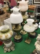 Four various Victorian brass and glass oil lamps together with a corinthian column type brass table