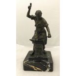 A modern patinated bronze study of a blacksmith at the anvil raised on a black marble base