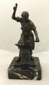 A modern patinated bronze study of a blacksmith at the anvil raised on a black marble base