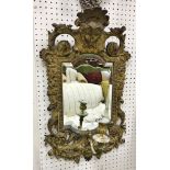 A pair of 19th Century Continental gilt brass girandole mirror with mask decorated surmounts and