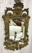 A pair of 19th Century Continental gilt brass girandole mirror with mask decorated surmounts and