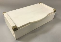 A 1930s ivory and horn lidded box of plain form in the Art Deco style