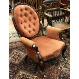 A Victorian walnut gentlemens salon chair with buttonback and showframe with red upholstery