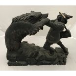 A black forest type carved treen ware figure group of man fighting bear