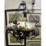 A modern black painted wrought iron and glazed pottery ceiling light