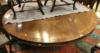 A modern mahogany circular dining table raised on central pedestal support CONDITION