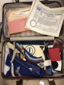 A suitcase and collection of Masonic regalia, badges, medallions, gauntlets, aprons,