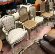 A pair of Louis XV style elbow chairs together with a pair of cane seated Louis XV style chairs