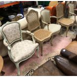 A pair of Louis XV style elbow chairs together with a pair of cane seated Louis XV style chairs