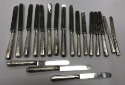 A collection of various silver sheathed handled steel dinner and dessert knives (various dates and