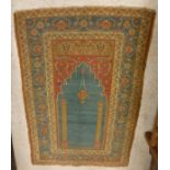 An Ushak prayer rug the central panel set with Mihab style design on a red ground within a blue,