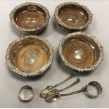 A set of four silver plated wine coasters,