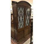 A Victorian mahogany and inlaid bookcase cabinet