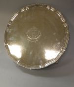A George III silver salver with beaded edge and piecrust rim raised on four claw and ball feet,
