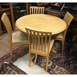 A modern stained beech kitchen table and four slat back oak dining chairs