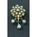 A 14 carat gold and opal set pendant / brooch,