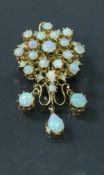 A 14 carat gold and opal set pendant / brooch,