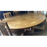 A modern oak and burr walnut veneered circular dining table,
