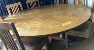 A modern oak and burr walnut veneered circular dining table,