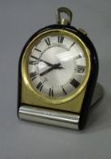 A mid 20th Century Jaeger Lecoultre folding travel clock with black lacquered mounts,