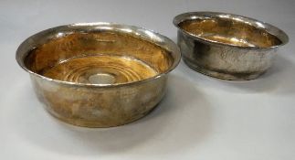 A pair of modern silver bottle coasters of hammered design with flared rims raised on circular foot