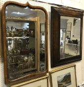 An oak cushion framed mirror together with a walnut framed miorror and a pine framed mirror