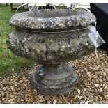 A composite stone garden urn of baluster form