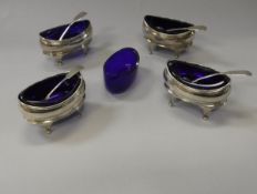 A set of four Regency silver oval open salts with cabriole legs and Bristol blue liners,