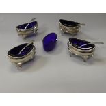 A set of four Regency silver oval open salts with cabriole legs and Bristol blue liners,